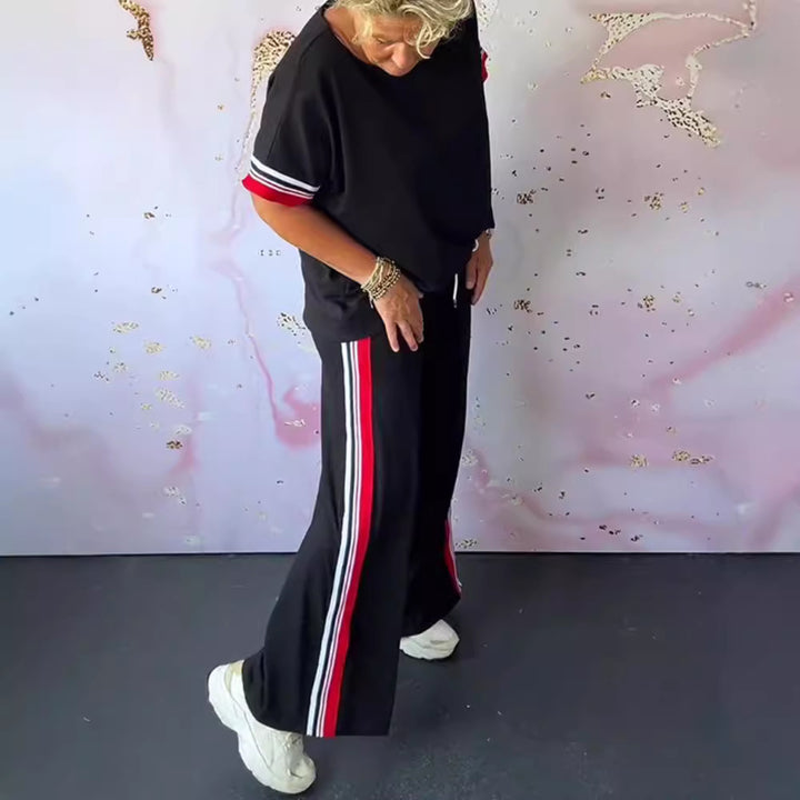 Ladies' sporty-elegant two-piece set with boxy short sleeve shirt, drawstring jog pants, and side contrast stripe StylebySassy