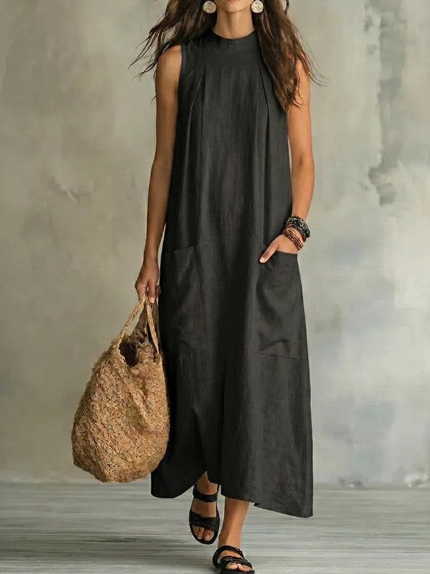 Women’s sleeveless linen maxi dress with standing collar, pleats at the chest, and piled pockets StylebySassy