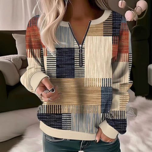 Women's cozy sweater with short zip, graphic patchwork pattern, extended sleeve cuffs, and ribbed hem StylebySassy