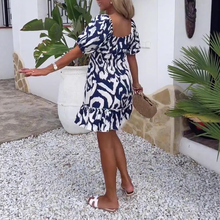 Women's short summer dress with square neckline, puff sleeves, and ruffle hem StylebySassy