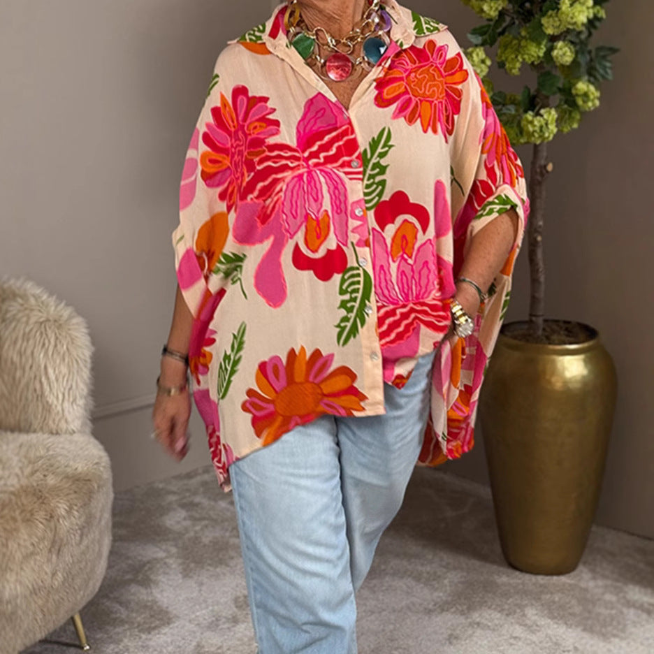 Women's airy oversized resort-style shirt blouse with large floral print and asymmetrical scalloped hem StylebySassy