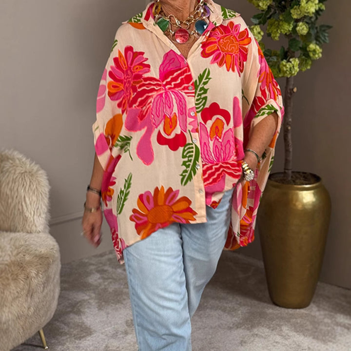 Women's airy oversized resort-style shirt blouse with large floral print and asymmetrical scalloped hem StylebySassy