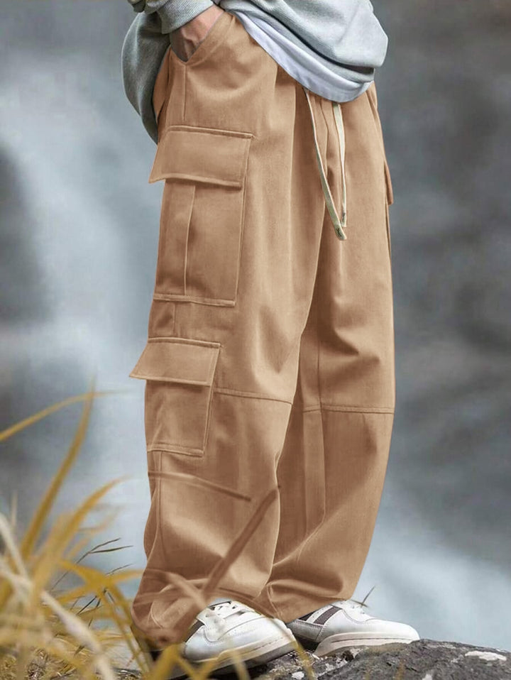 Men's casually cut multiple pockets cargo pants with wide leg and prominent knee darts StylebySassy