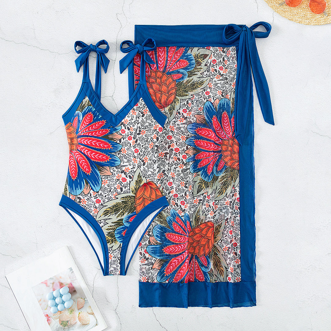 Women's one-piece swimsuit with playful floral design and stylish wrap skirt StylebySassy