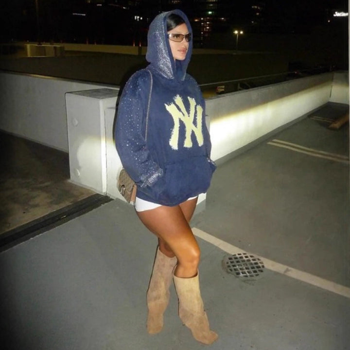 Women's oversized hoodie made of velvet fleece with distinctive logo print, glitter trim, and kangaroo pocket StylebySassy