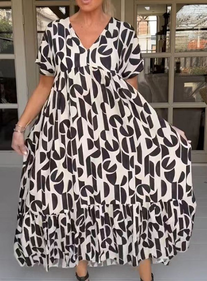 Women's voluminous maxi dress with under-bust seam, V-neck, short kimono sleeves, and tiered ruffle StylebySassy