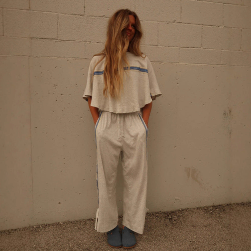 Ladies two-piece leisure ensemble with boxy ruffle top and wide cord pants with side decorative stripe StylebySassy