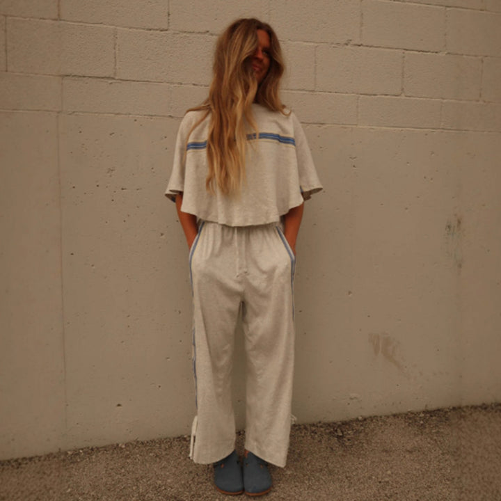 Ladies two-piece leisure ensemble with boxy ruffle top and wide cord pants with side decorative stripe StylebySassy