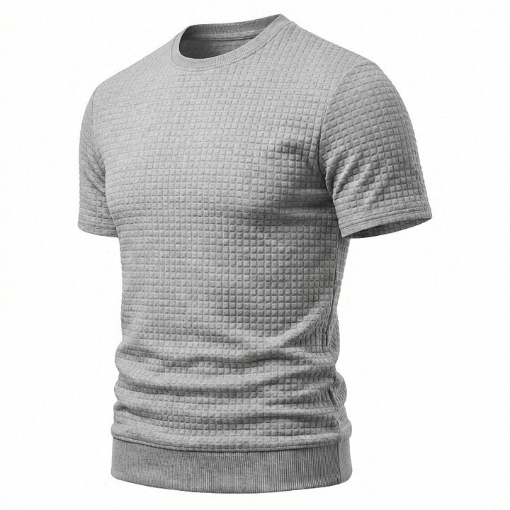 Men's short-sleeved knit shirt with embossed check structure, round neckline, and ribbed hem StylebySassy