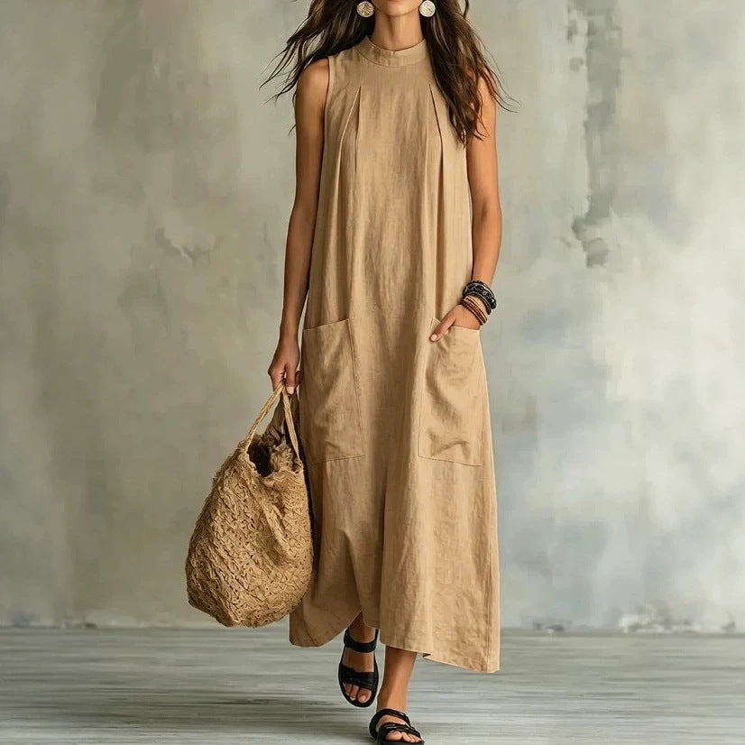 Women’s sleeveless linen maxi dress with standing collar, pleats at the chest, and piled pockets StylebySassy