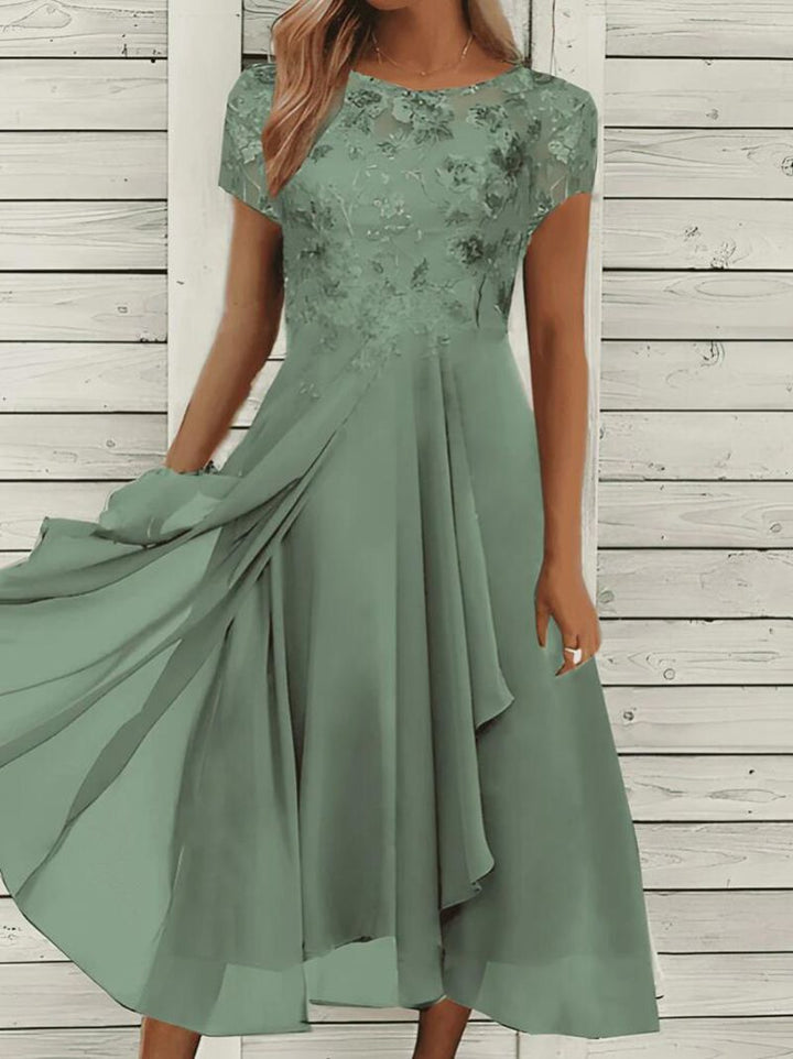 Women's flowing chiffon mid dress with floral embroidered top and asymmetrical tiered skirt StylebySassy