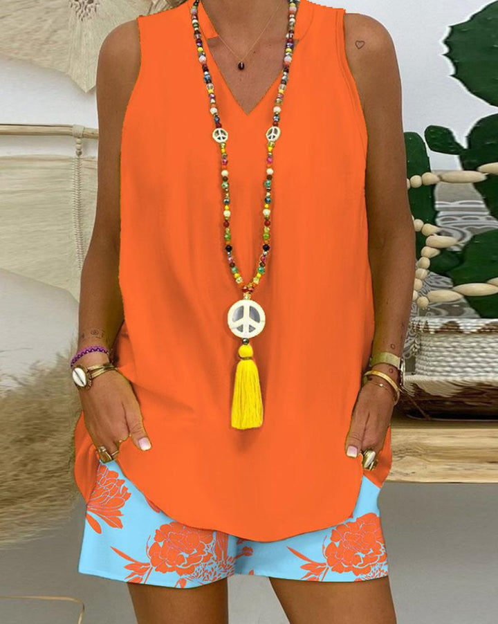 Women's sleeveless V-neck long top with curved hem and side insertion pockets StylebySassy