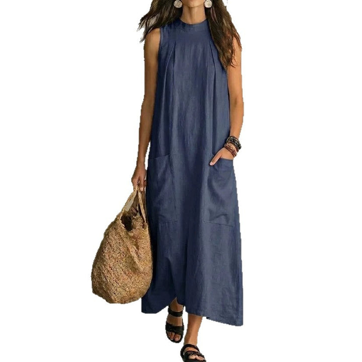 Women’s sleeveless linen maxi dress with standing collar, pleats at the chest, and piled pockets StylebySassy