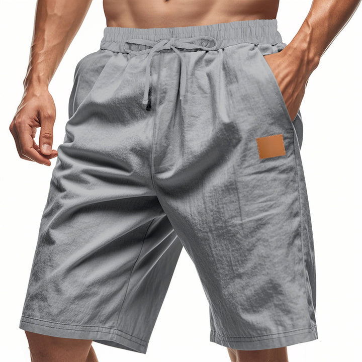 Men's lightweight casual Bermuda shorts with elastic waistband, drawstring and discreet leather application StylebySassy