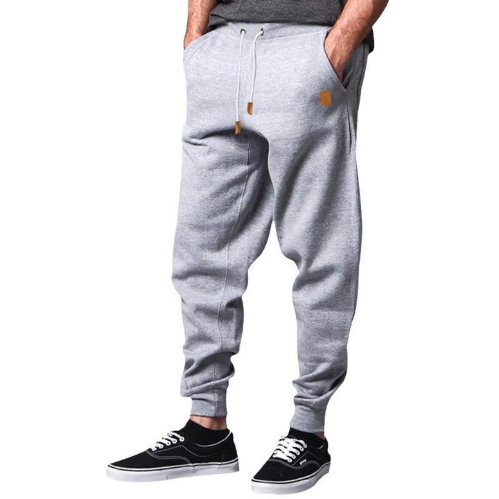 Men's tapered leisure pants made of sweat fabric with elastic waistband, drawstring, and ribbed cuffs StylebySassy