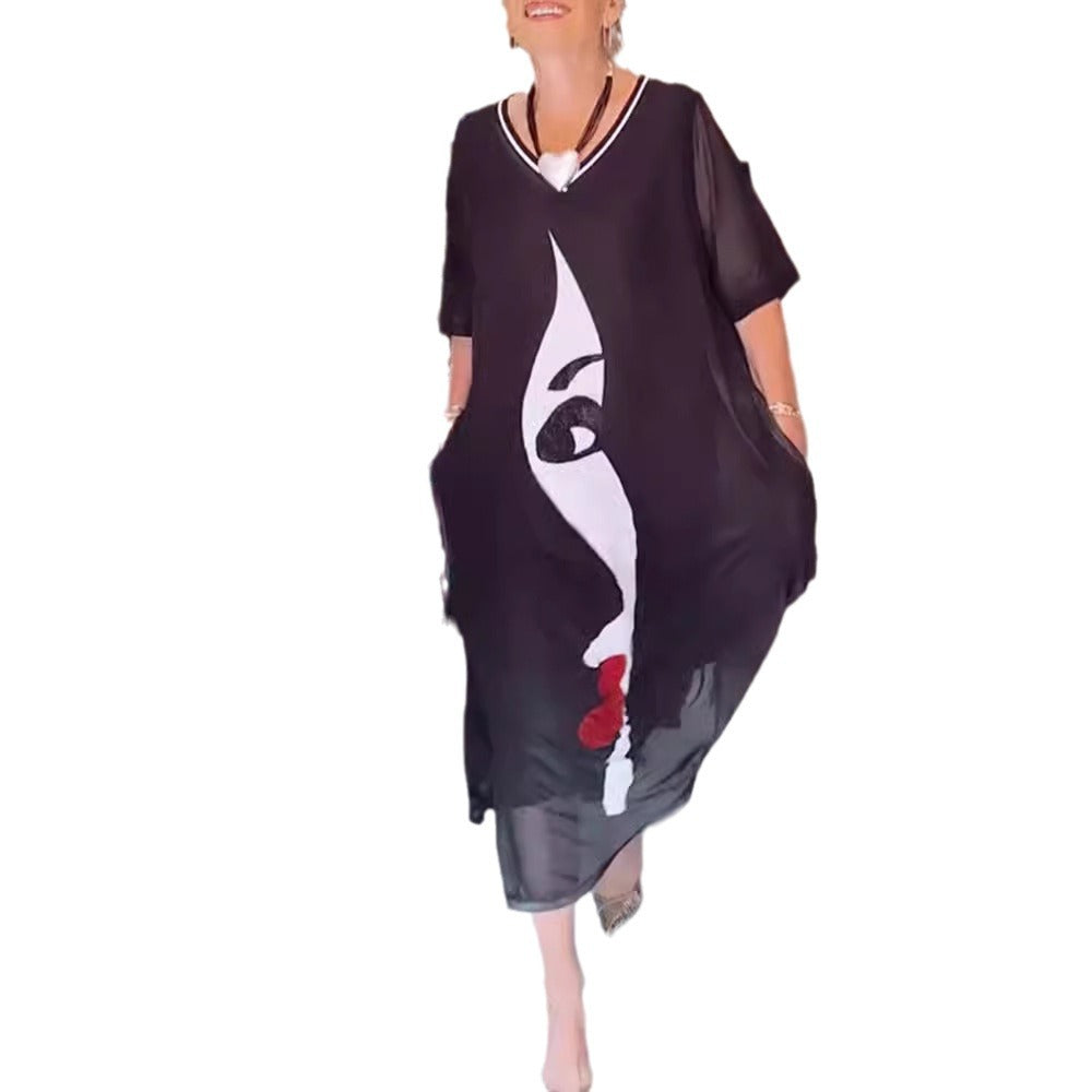 Women's airy chiffon maxi dress with graphic face print, V-neck and side pockets StylebySassy