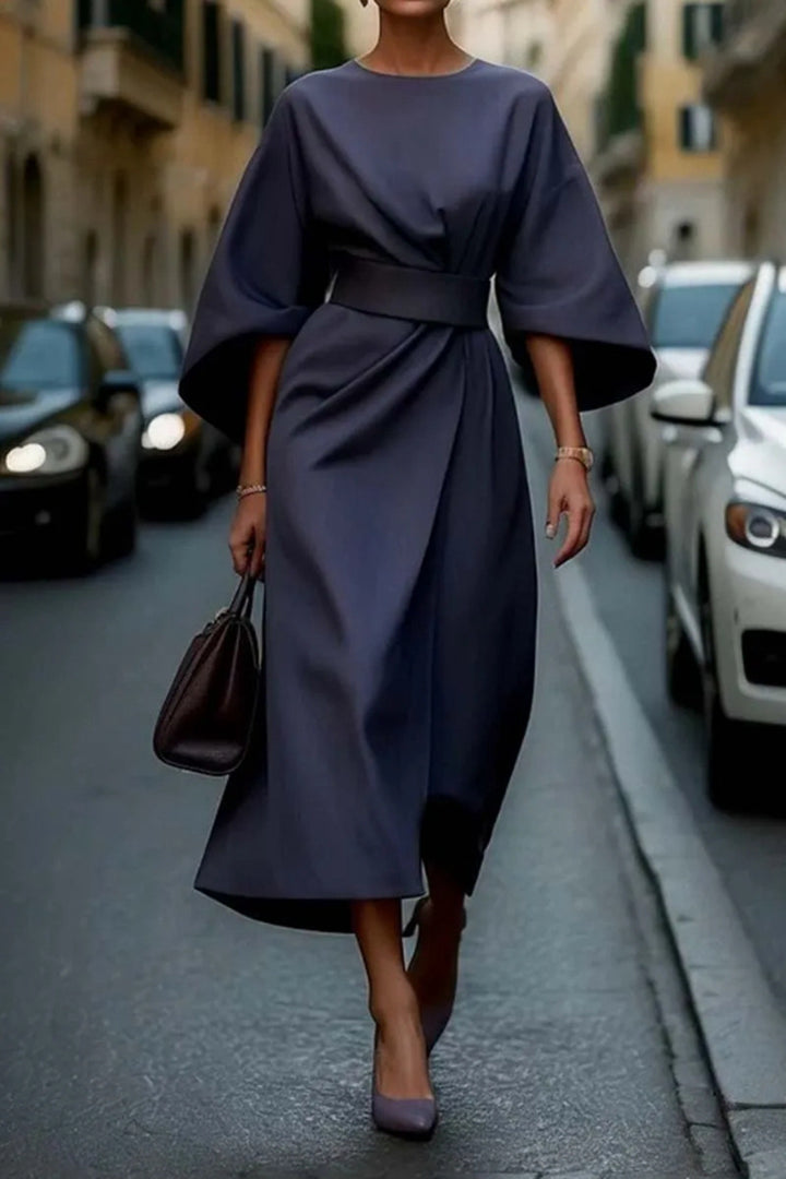 Women's minimalist evening dress with overlong wide sleeves and waist-sculpting pleat draping StylebySassy