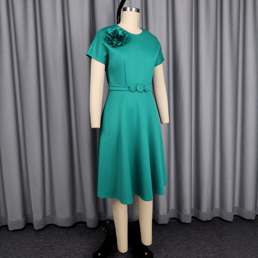 Women's dress with elegant belt and decorative flower accent StylebySassy