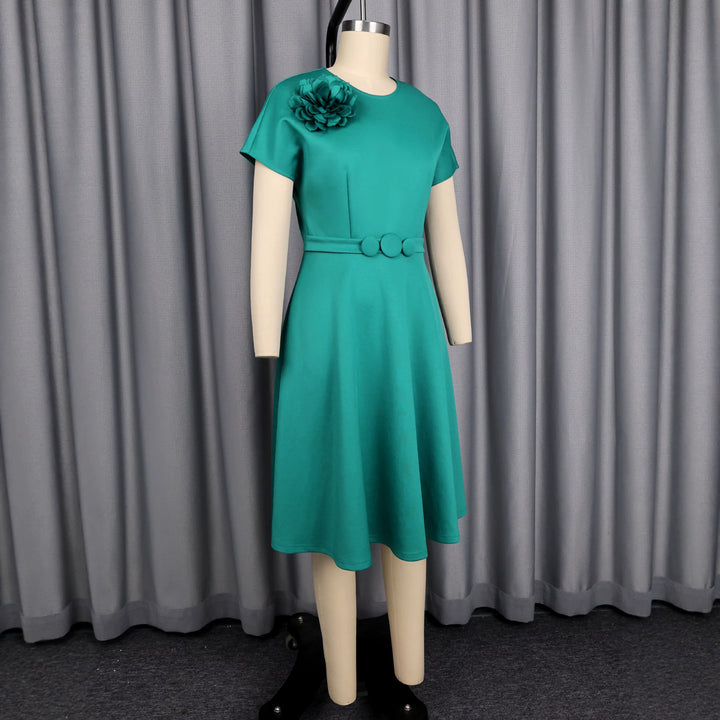 Women's dress with elegant belt and decorative flower accent StylebySassy