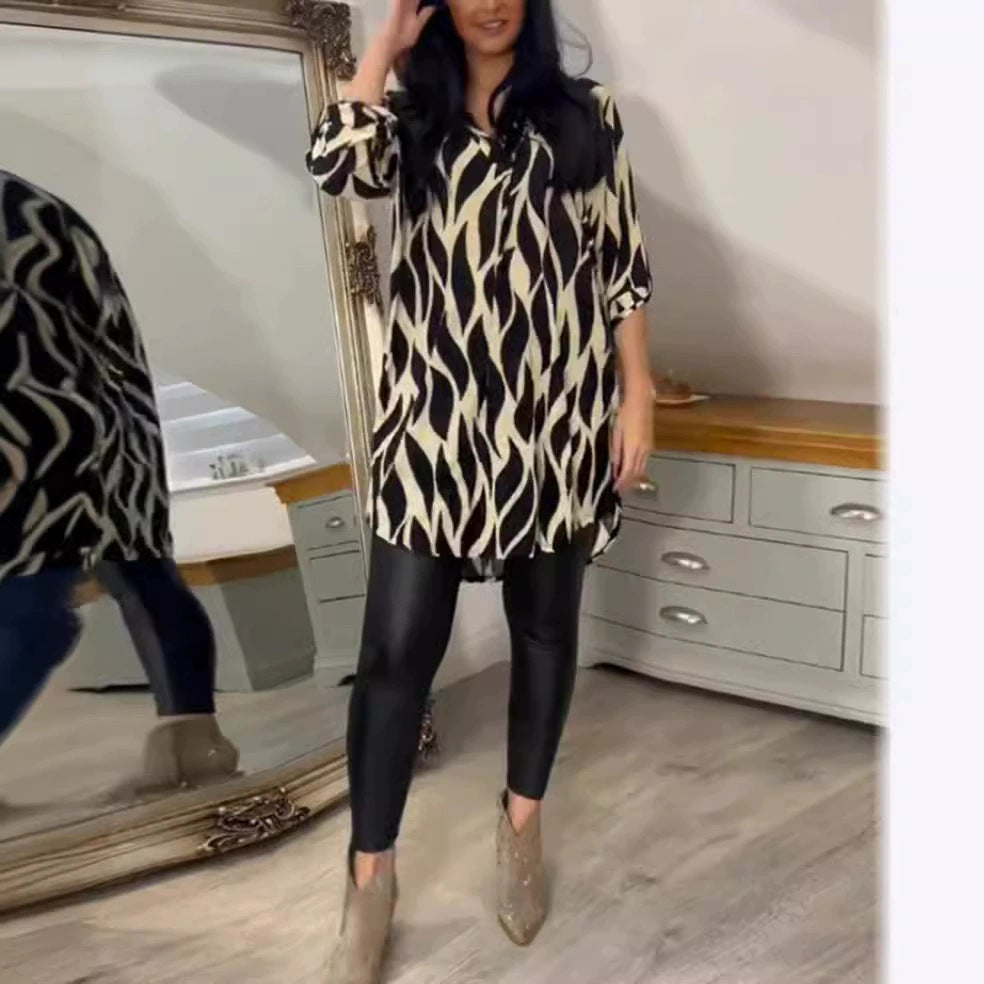 Women's oversized tunic blouse with organic leaf print, V-neckline, half button placket, and rounded hem StylebySassy