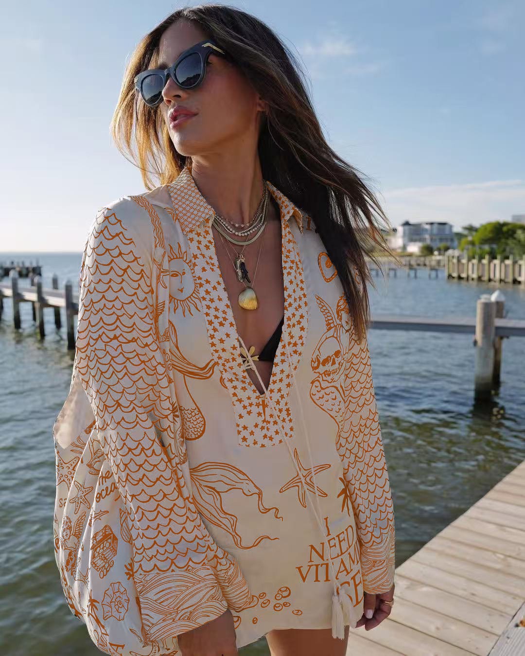 Ladies lightweight beach cover-up in tunic form with deep V-neck, tassel closure, and nautical ocean print StylebySassy