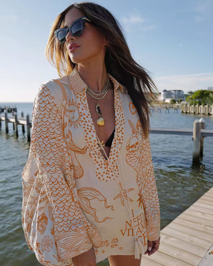 Ladies lightweight beach cover-up in tunic form with deep V-neck, tassel closure, and nautical ocean print StylebySassy
