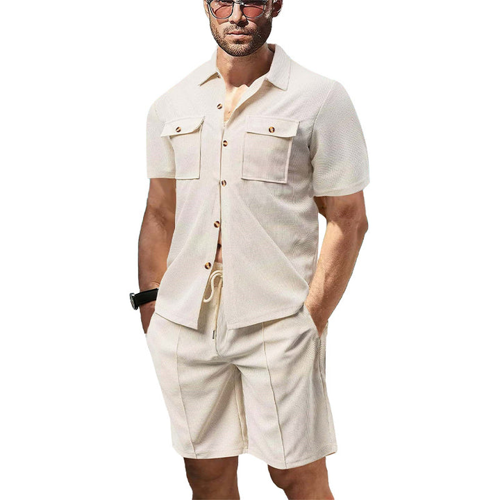 Men's modern short-sleeve shirt set in resort style with patch pockets, open lapel collar, and drawstring Bermuda shorts made of textured jersey StylebySassy