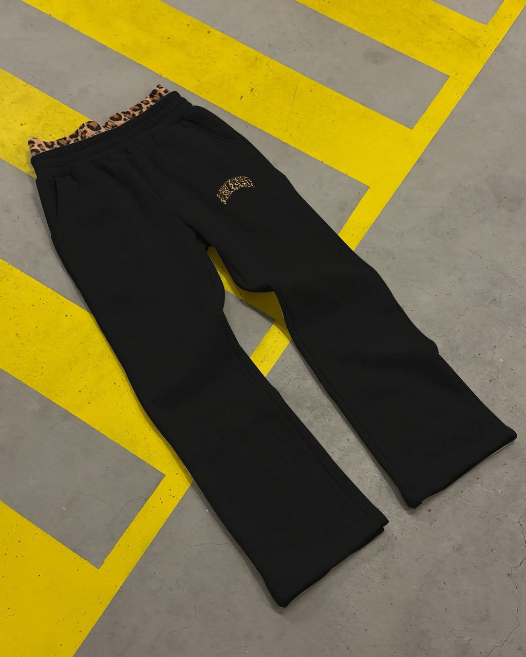 Women's high-cut jogging pants with flared leg, elastic ruffled waistband and leopard stitch detail StylebySassy