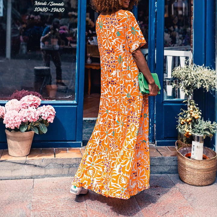Women’s ankle-length V-neck maxi dress with graphic ethnic print, short sleeves and flared ruffle hem StylebySassy