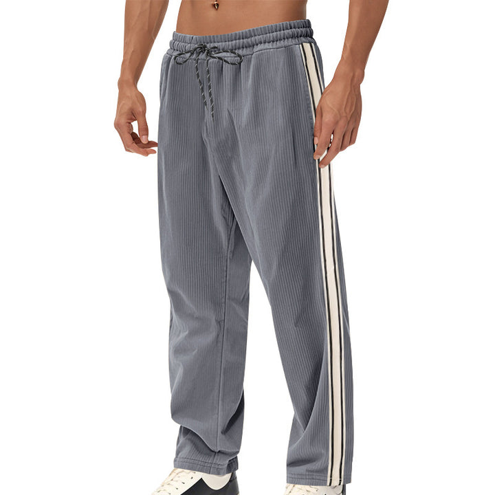 Men's loose training pants in corduroy look with drawstring waistband and side contrast stripes StylebySassy