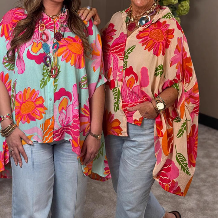 Women's airy oversized resort-style shirt blouse with large floral print and asymmetrical scalloped hem StylebySassy