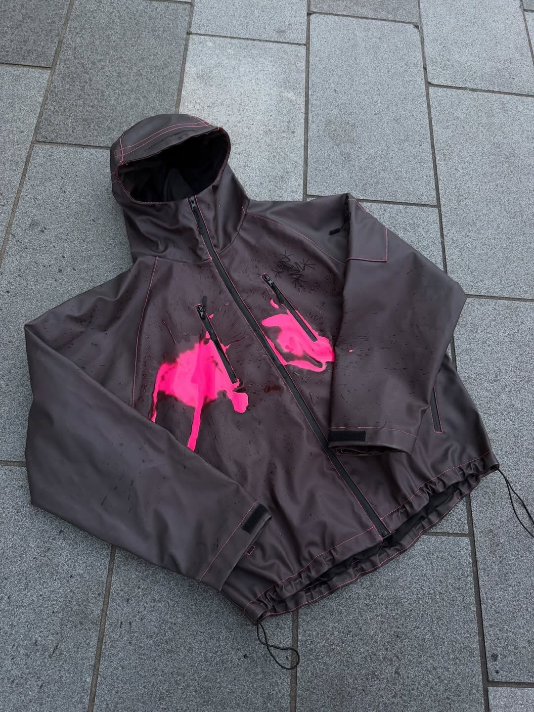 Unisex nan technical rain jacket with welded seams, slanted chest zip pockets, and adjustable drawstring hem StylebySassy