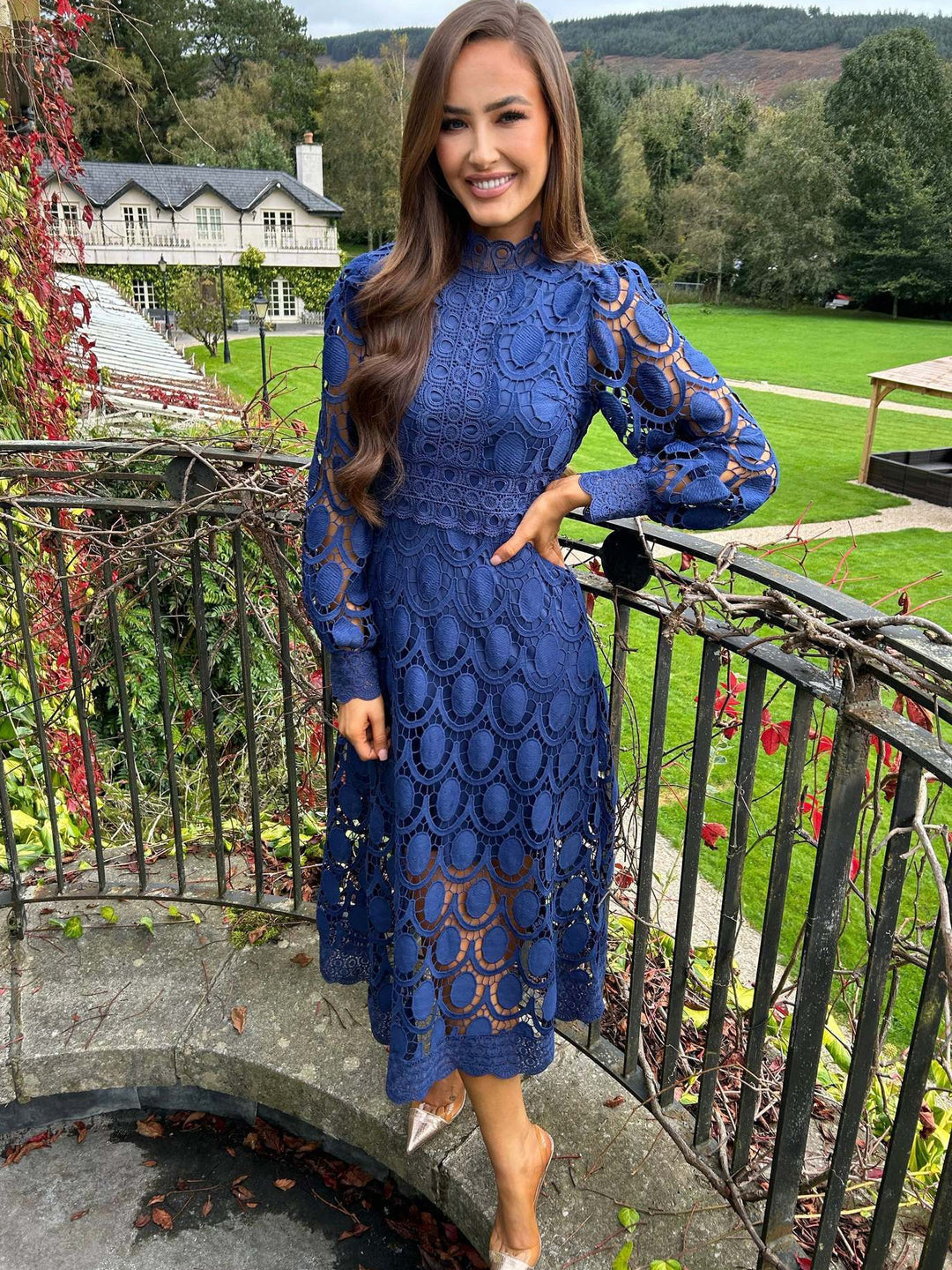 Women's crocheted midi dress with stand-up collar, transparent lace sleeves, and fitted A-line StylebySassy
