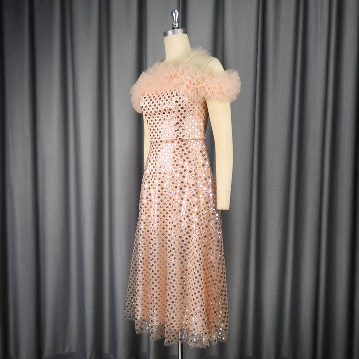 Women’s festive evening dress with voluminous ruffle details and delicate glitter StylebySassy