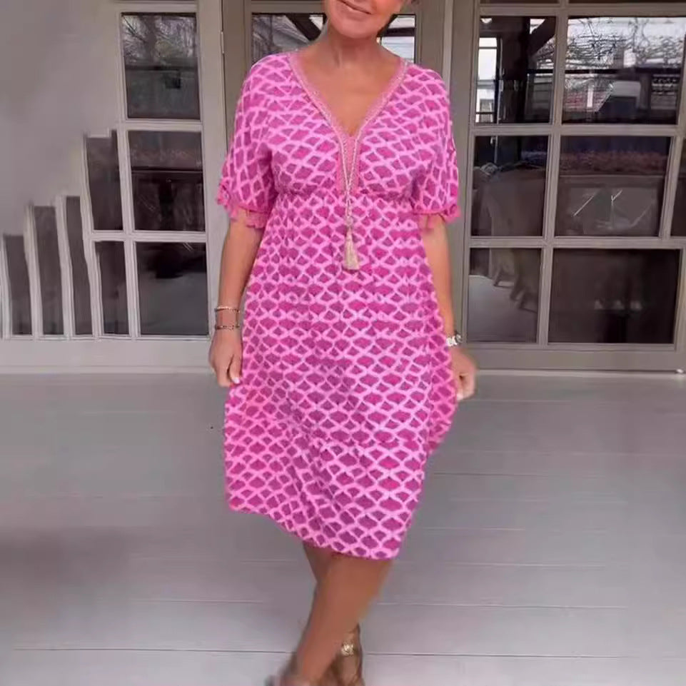 Women's casual midi dress in kaftan style with V-neck, tassel band, gathered empire seam, and fringe sleeves StylebySassy