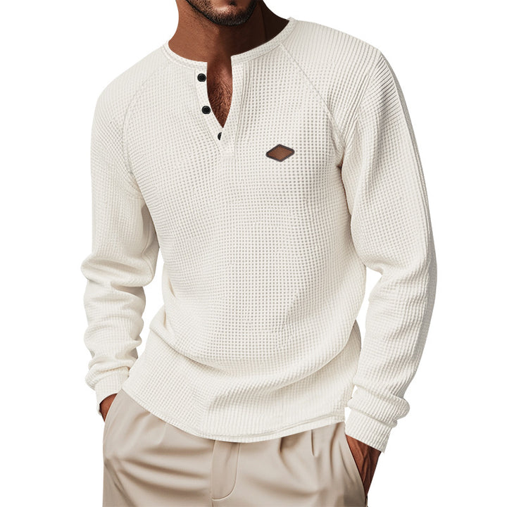 Men's structured long-sleeve shirt with short button placket, raglan sleeves, and subtle logo application StylebySassy