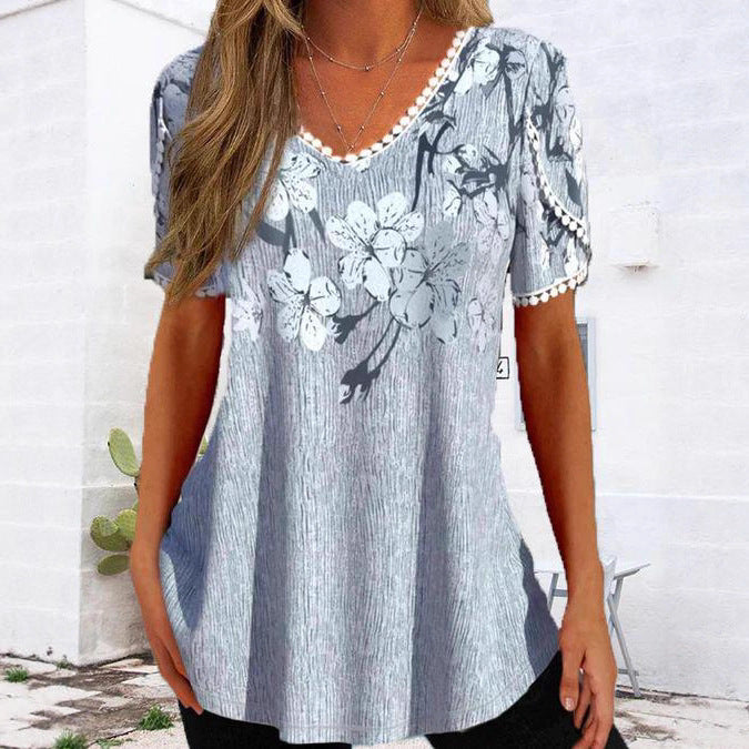 Women's flowing V-neck tunic top with floral print pompom trim and A-line cut StylebySassy