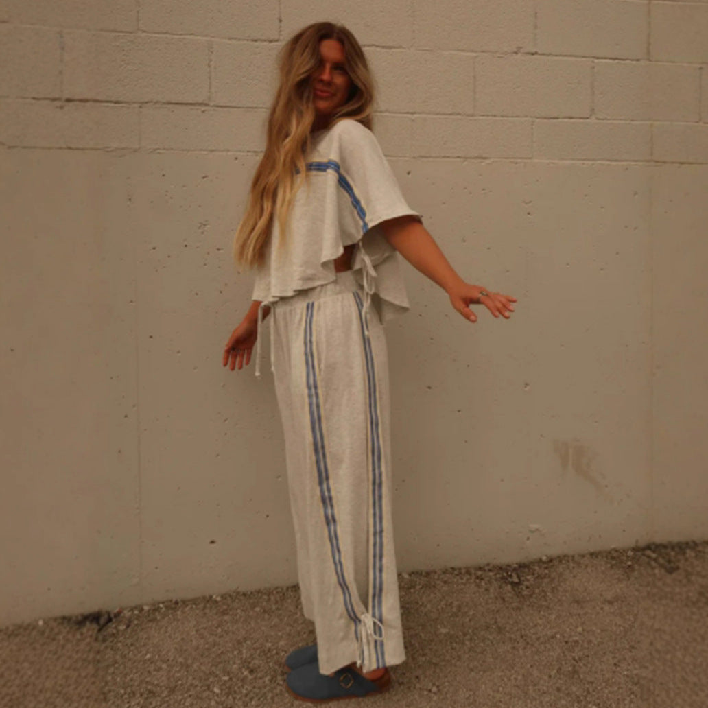 Ladies two-piece leisure ensemble with boxy ruffle top and wide cord pants with side decorative stripe StylebySassy