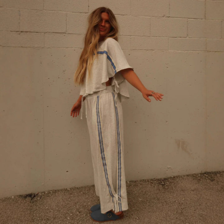Ladies two-piece leisure ensemble with boxy ruffle top and wide cord pants with side decorative stripe StylebySassy