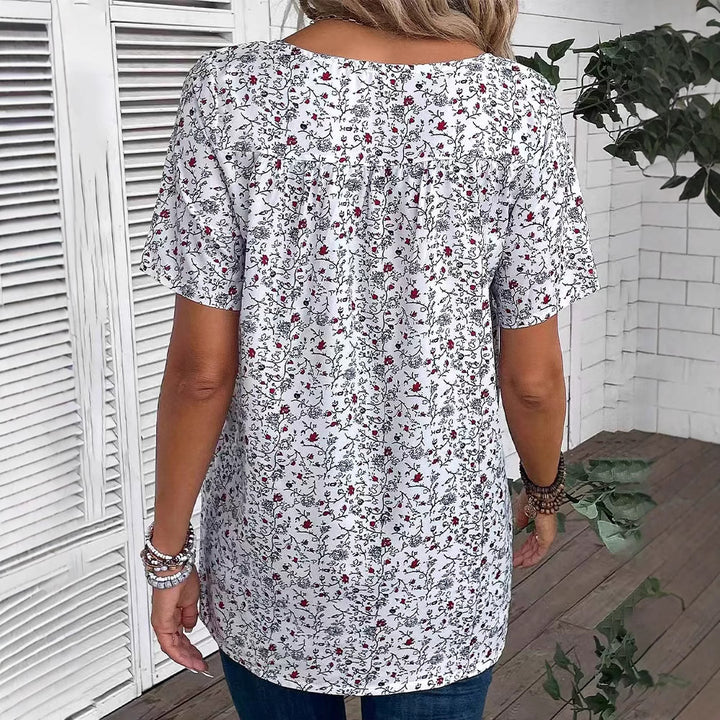 Ladies casual short-sleeve tunic shirt with round neckline, delicate all-over floral print and decorative chest pleats StylebySassy
