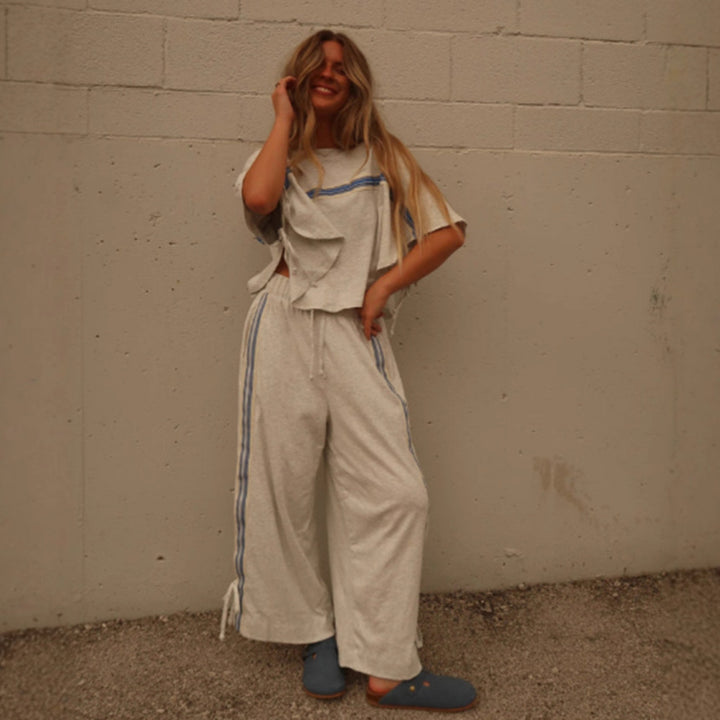 Ladies two-piece leisure ensemble with boxy ruffle top and wide cord pants with side decorative stripe StylebySassy