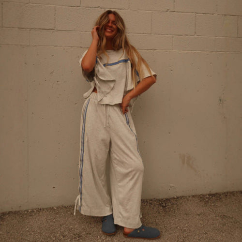 Ladies two-piece leisure ensemble with boxy ruffle top and wide cord pants with side decorative stripe StylebySassy