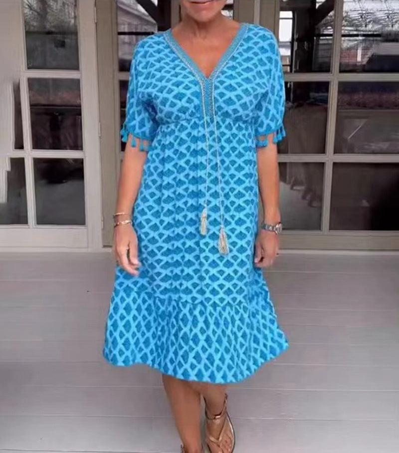 Women's casual midi dress in kaftan style with V-neck, tassel band, gathered empire seam, and fringe sleeves StylebySassy