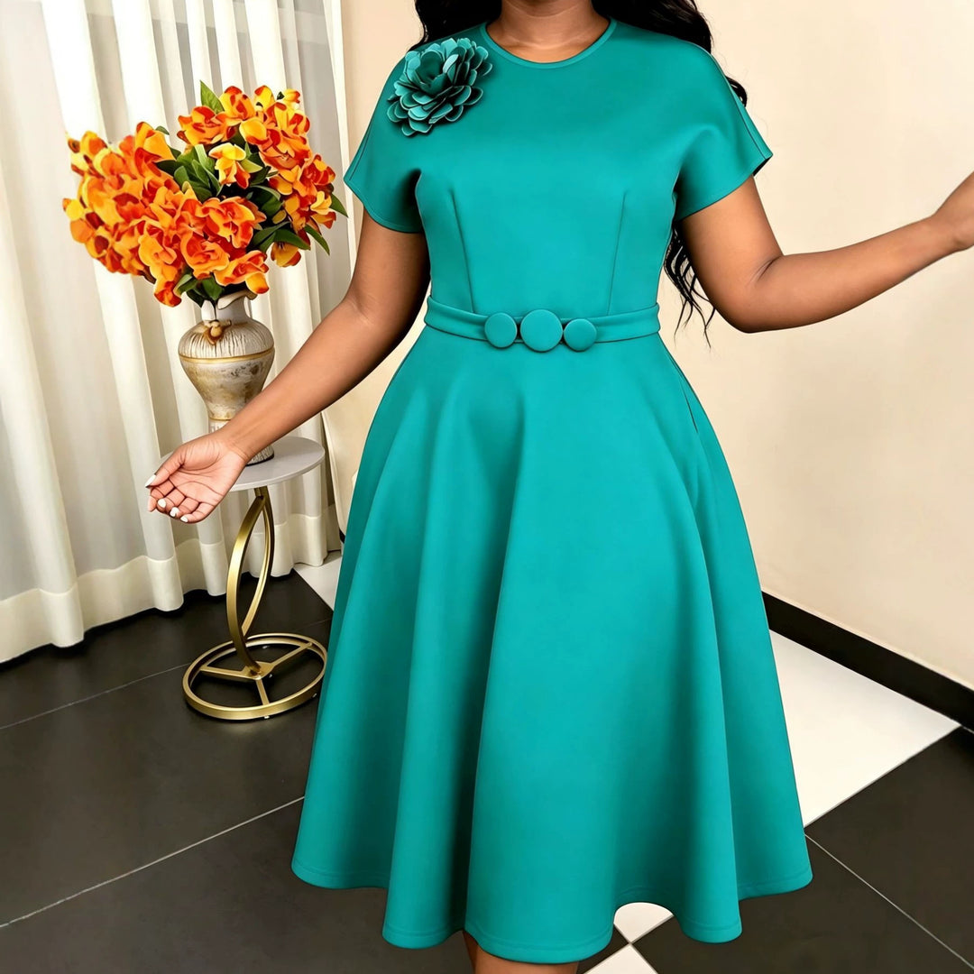 Women's dress with elegant belt and decorative flower accent StylebySassy