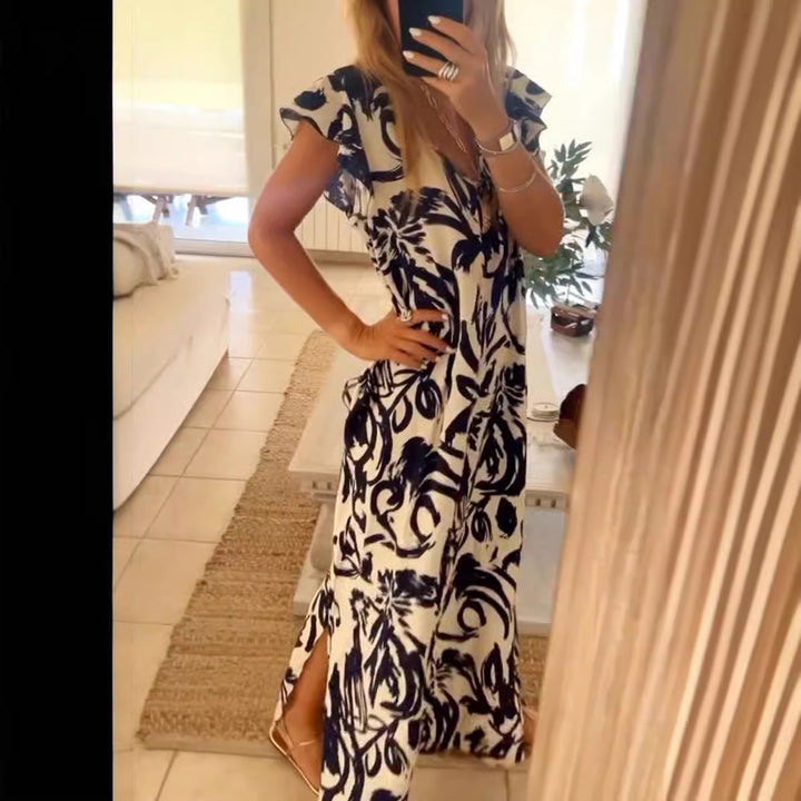 Women's flowing maxi dress with V-neck, flutter sleeves, and side leg slit StylebySassy