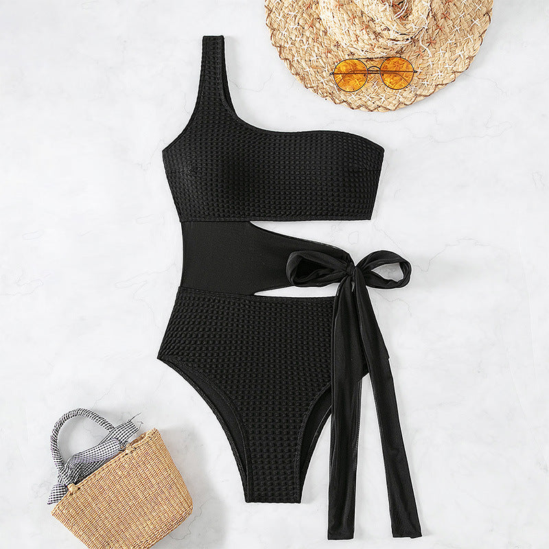 Women's one-piece swimsuit with asymmetrical cut and stylish wrap belt StylebySassy