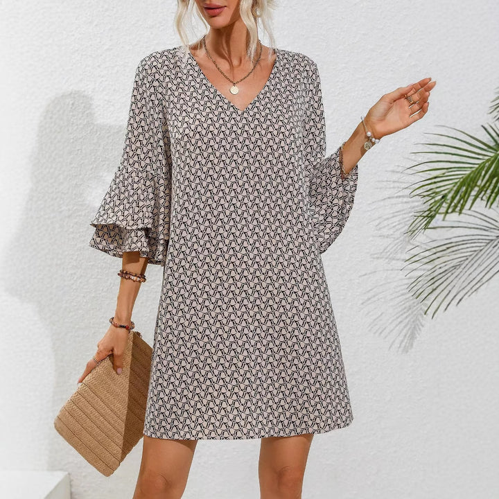 Women's flowing tunic mini dress with V-neck graphic chain pattern and double-layered bell sleeves StylebySassy