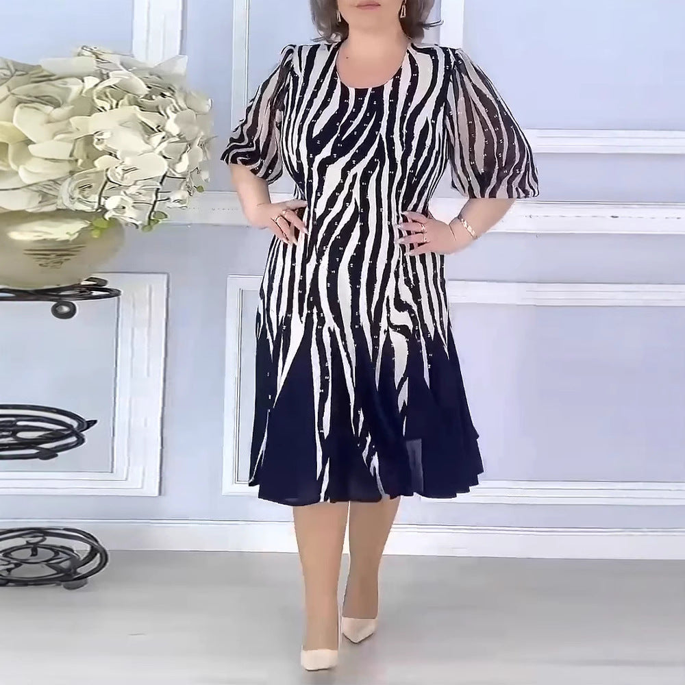 Ladies' fitted midi dress with graphic animal print, transparent puff sleeves and swinging pleated skirt StylebySassy