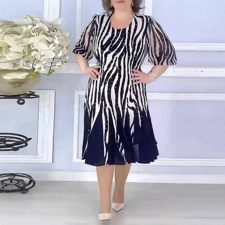 Ladies' fitted midi dress with graphic animal print, transparent puff sleeves and swinging pleated skirt StylebySassy