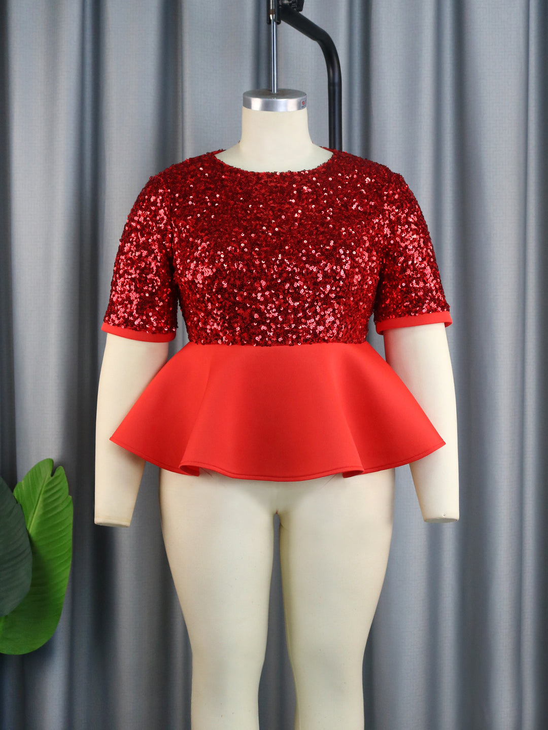 Ladies elegant glitter top with swinging peplum